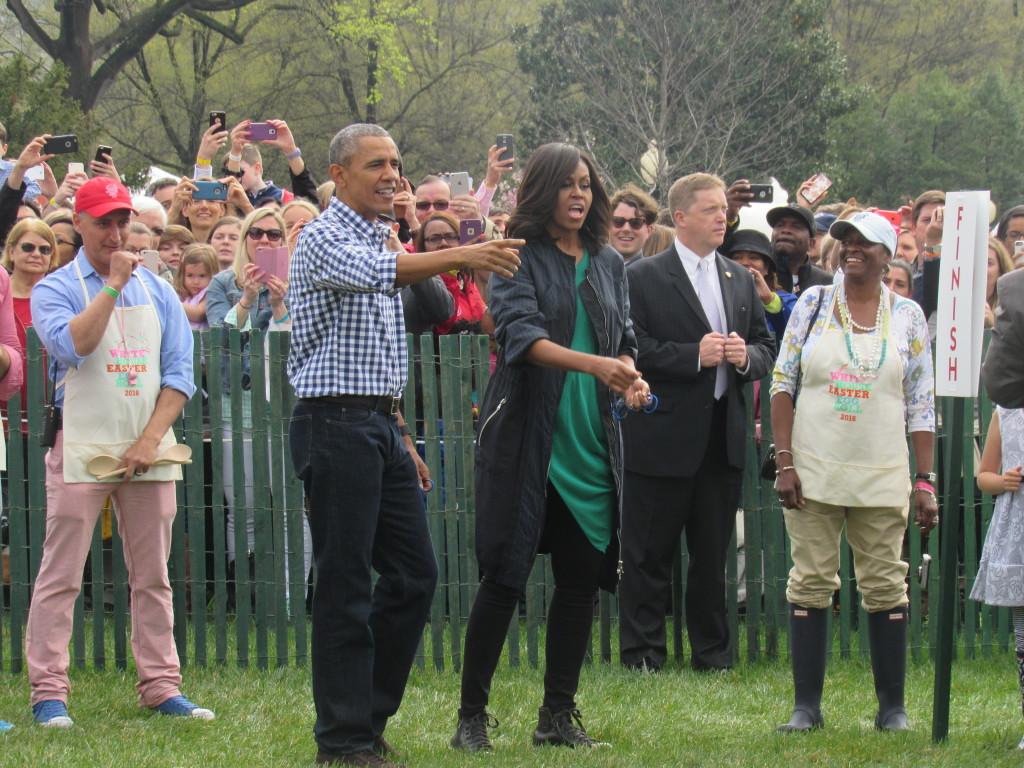 Barack and Michelle Obama assisting little girl down the finish line of the egg roll. (photo: Sara Monterroso) 