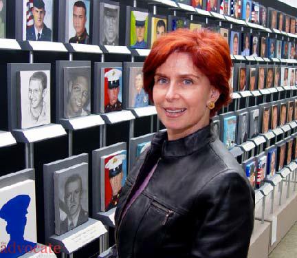 Annete Polan stands beside her work “Faces of the Fallen”. -- Steve Yu