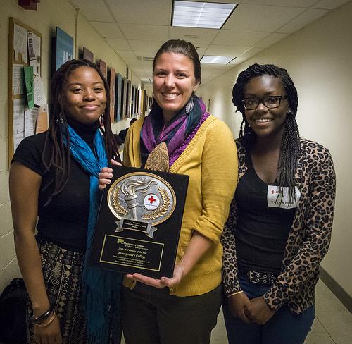 The Office of Student Lifes staff proudly accepts Red Cross award in behalf of blood donations