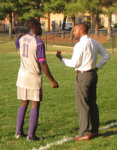 Freshman Gabriel Ndiave, 11 receives strategy instructions from head coach Pedro Braz. (Photo Credit: Kevin Ortiz)