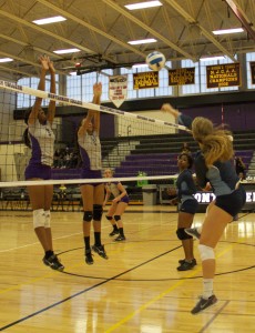 Freshman Kapria Redparth, 6, and Sophomore Yesenia Mora, 2, blocking the ball. (Photo Credit: Adriano Cassoma)