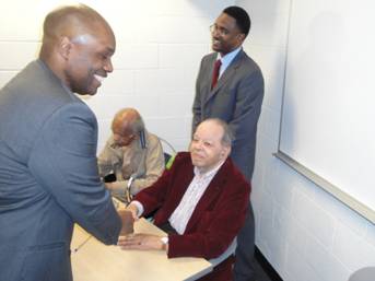 Derrick Douglass shakes hands with Airman First Lieutenant Floyd Collins alongside First Lieutenant Wylie W. Selden. (Photo Credit: Derrick Douglass)