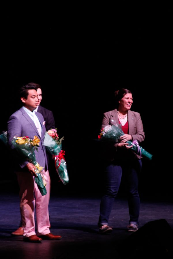 Erick presenting thank you flowers to Nik