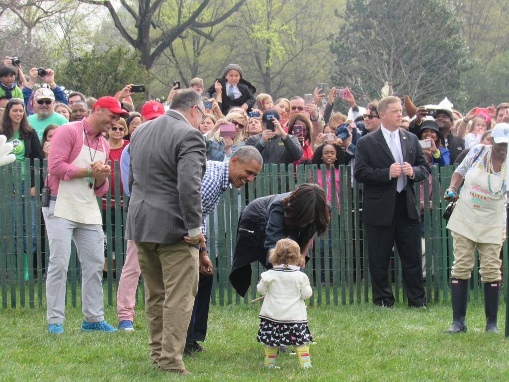 Barack and Michelle Obama assisting little girl down the finish line of the egg roll. (photo: Sara Monterroso) 