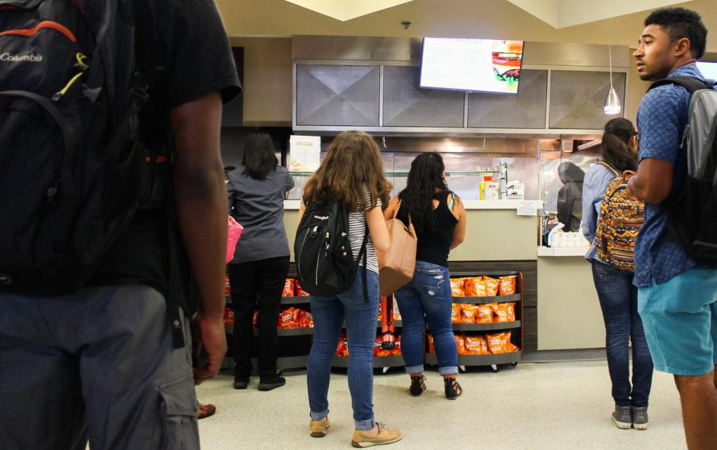Students waiting in line to grab lunch at the MC Cafe