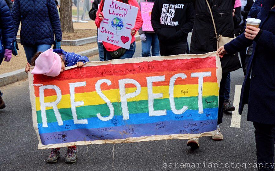 Little girl and her mother promote respect through a hand-made banner signed by family and friends.  (photo: Sara Monterroso) 