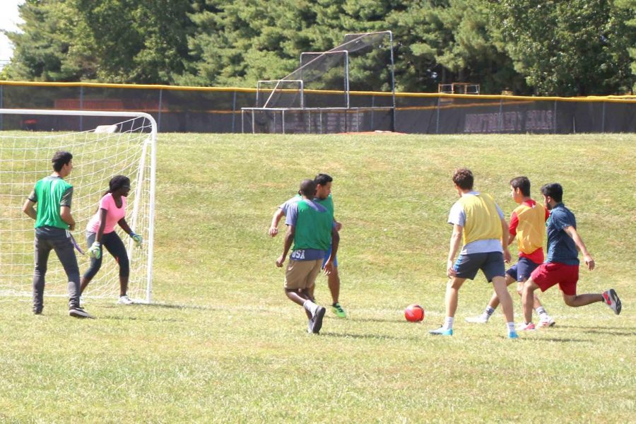 Students attacking for the ball during a friendly green vs. yellow match.