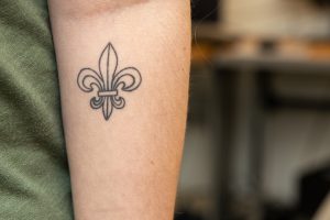 A fleur de lis on Maia Cafri's forearm. 