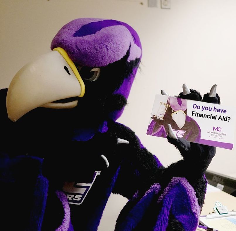 The MC Raptor holding the Financial Aid Flyer. Photo: Courtesy of Montgomery College.