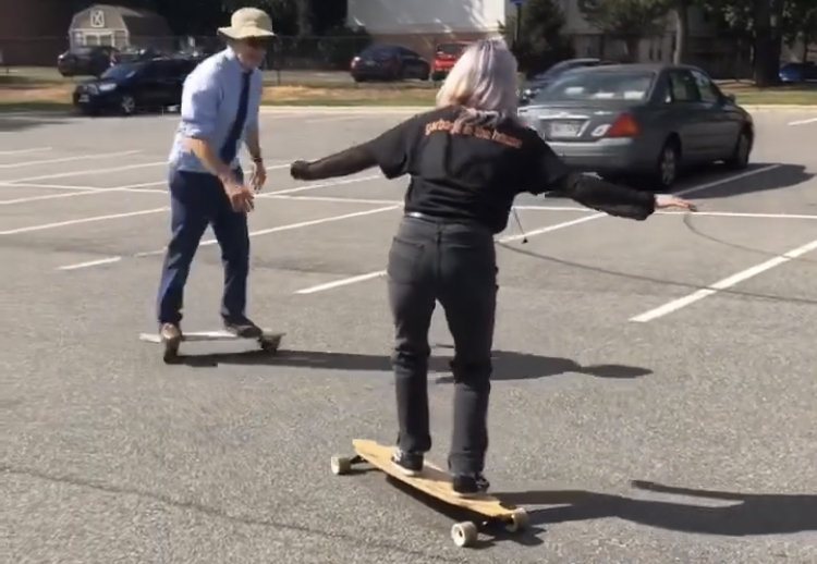 Alana McCarthy Light long boarding with Professor Albert Kapikian on the skateboard.
