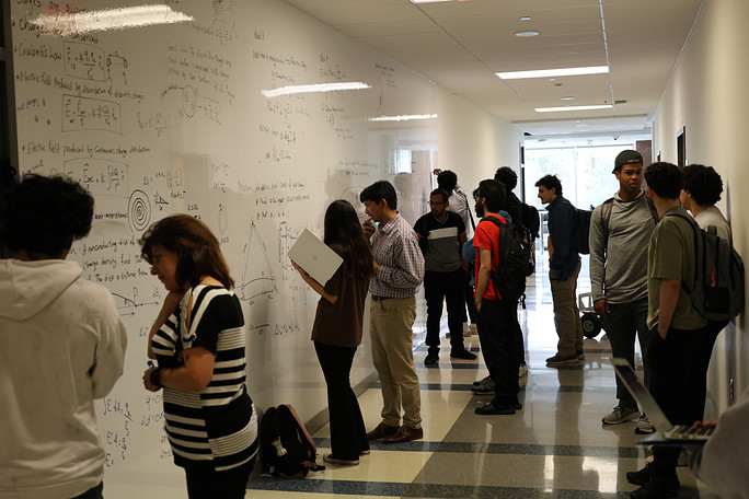Instructors and students collaborate by using the Physics 262 whiteboard.