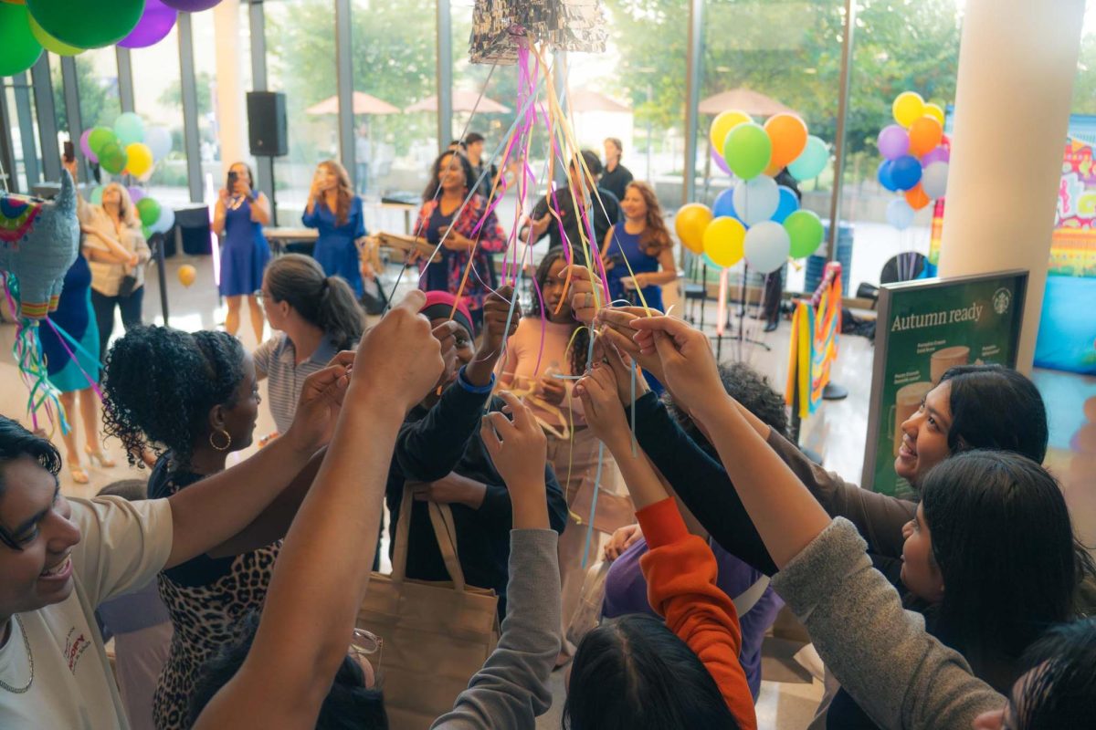 Students release sweet treats from the piñata (Photo Credit: Yabez Jackson)