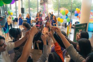 Students release sweet treats from the piñata (Photo Credit: Yabez Jackson)