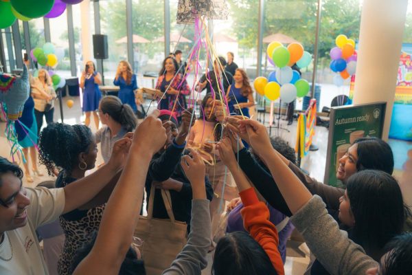 Students release sweet treats from the piñata (Photo Credit: Yabez Jackson)